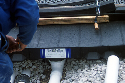track pan below grade piping